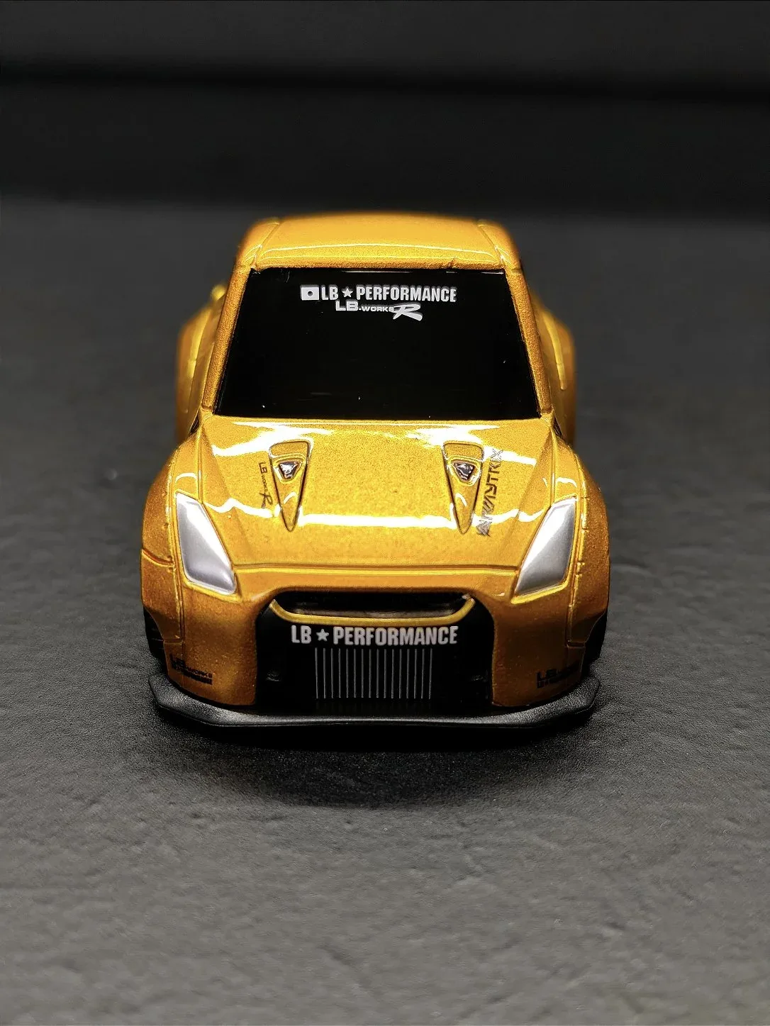 MINI GT - NISSAN GT-R (R35) TYPE 1, REAR WING VER 2 LB GOLD - QUBE CARZ